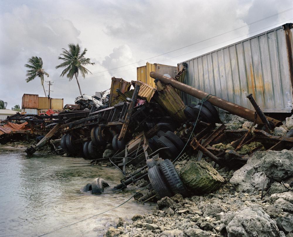 Magnum photographer Chris Steele-Perkins took this image in 2004 in Majuro, Marshall Islands. Because of the sea level rises and makes the Pacific Ocean a constant threat, containers filled with rocks and heavy objects are installed along the shore.